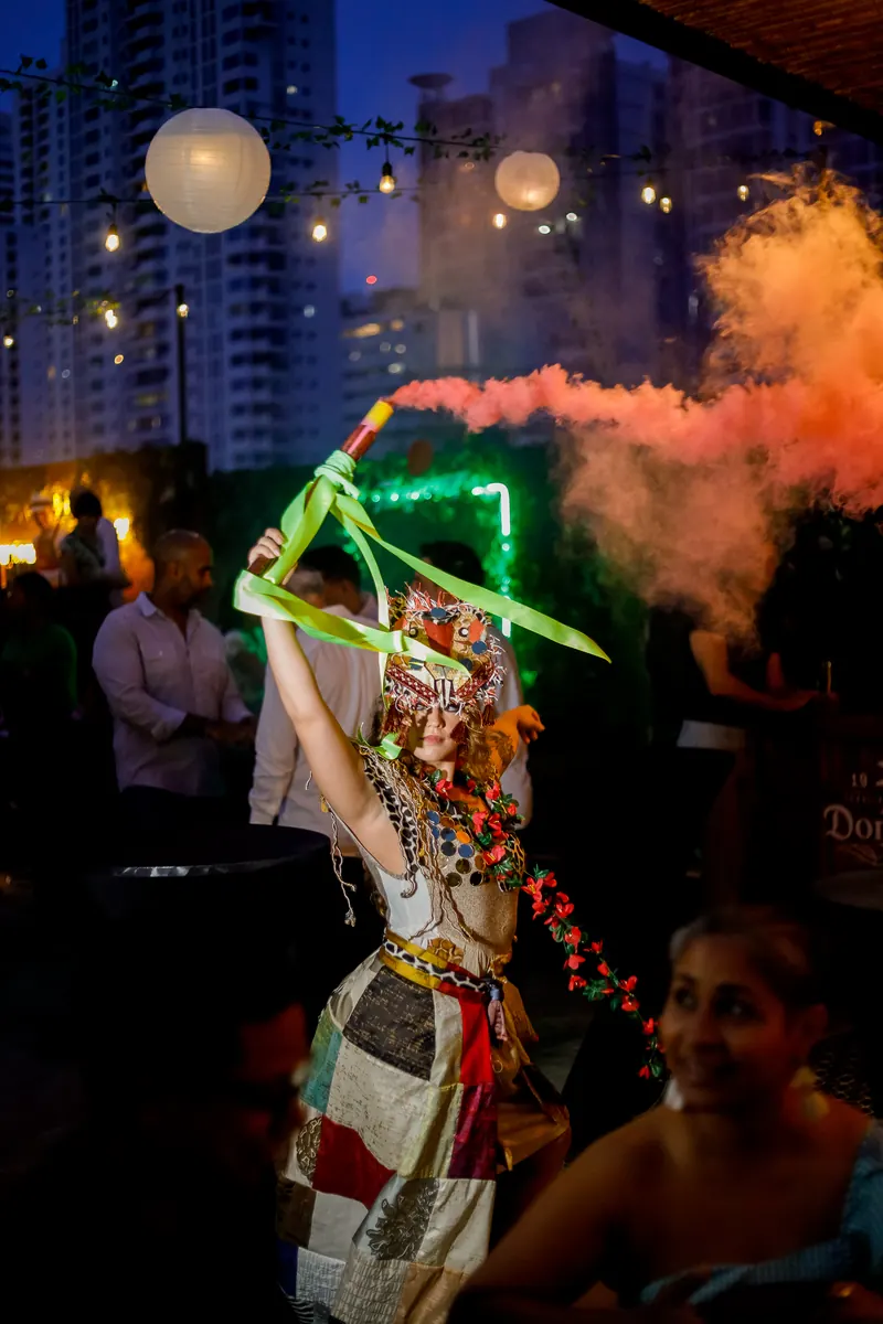 Dancer with colored smoke on a themed night at Terrat