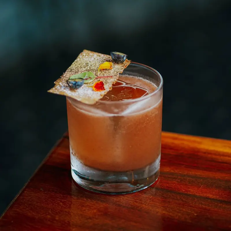 Signature cocktail with an edible garnish at the Terrat bar