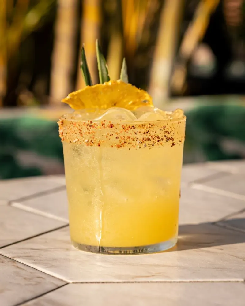 Tropical cocktail with a chili rim and dried pineapple at Terrat
