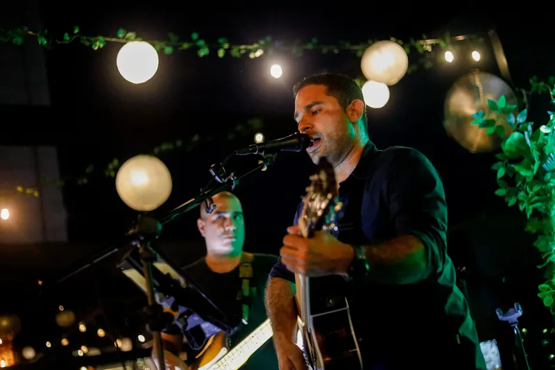 Singer with guitar on a live music night at Terrat