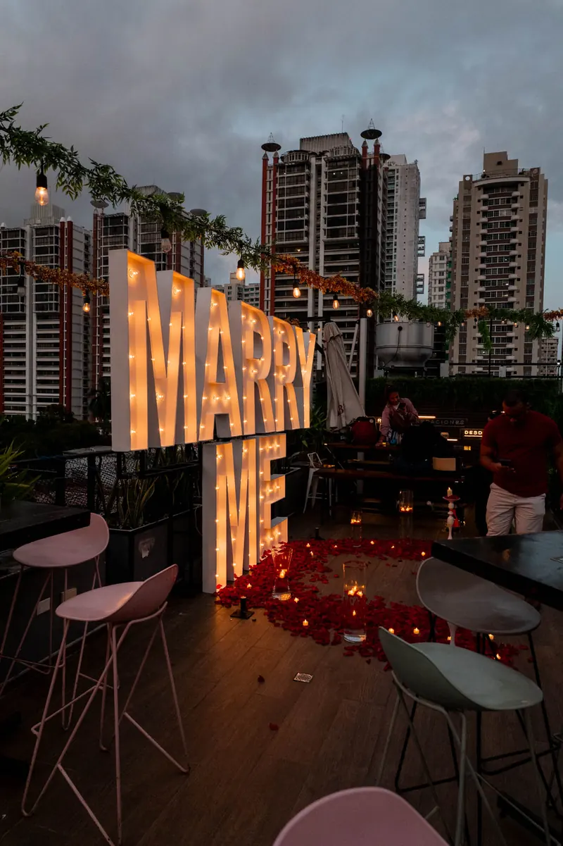 Illuminated “Marry Me” letters for a proposal on the Terrat terrace
