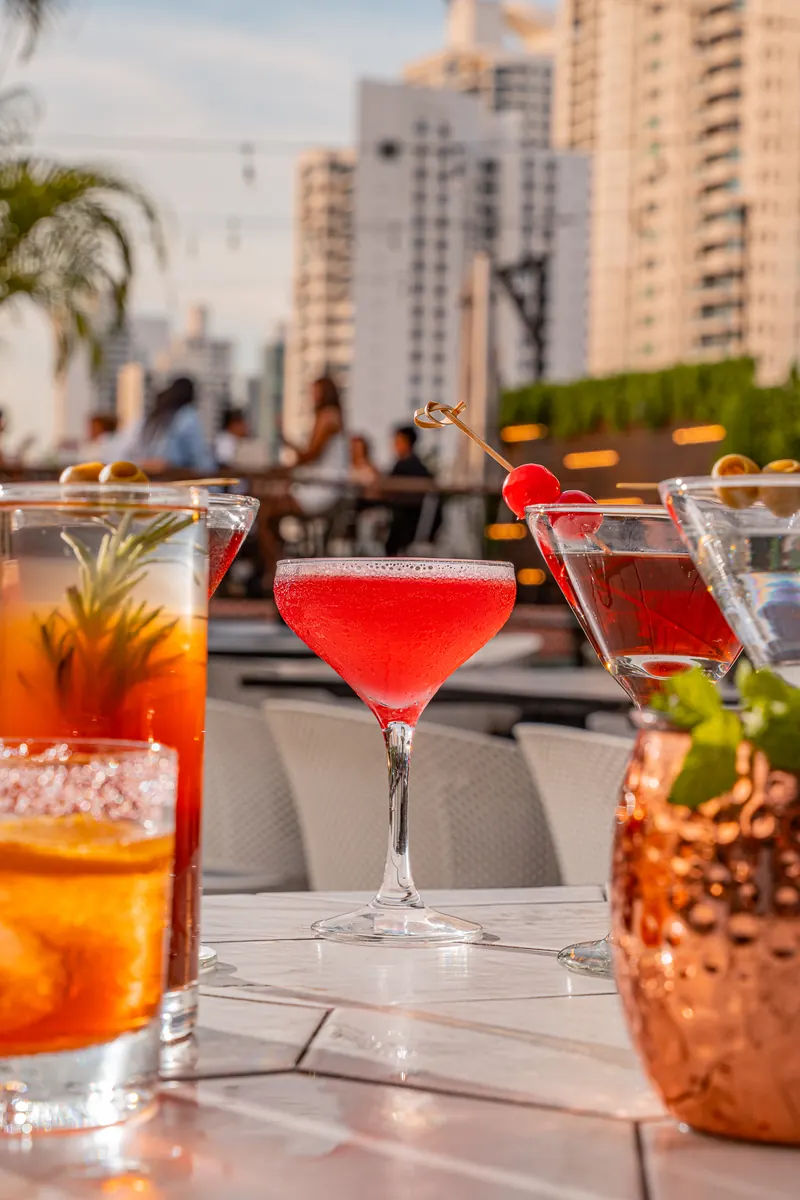 Happy hour cocktails with the city behind at Terrat
