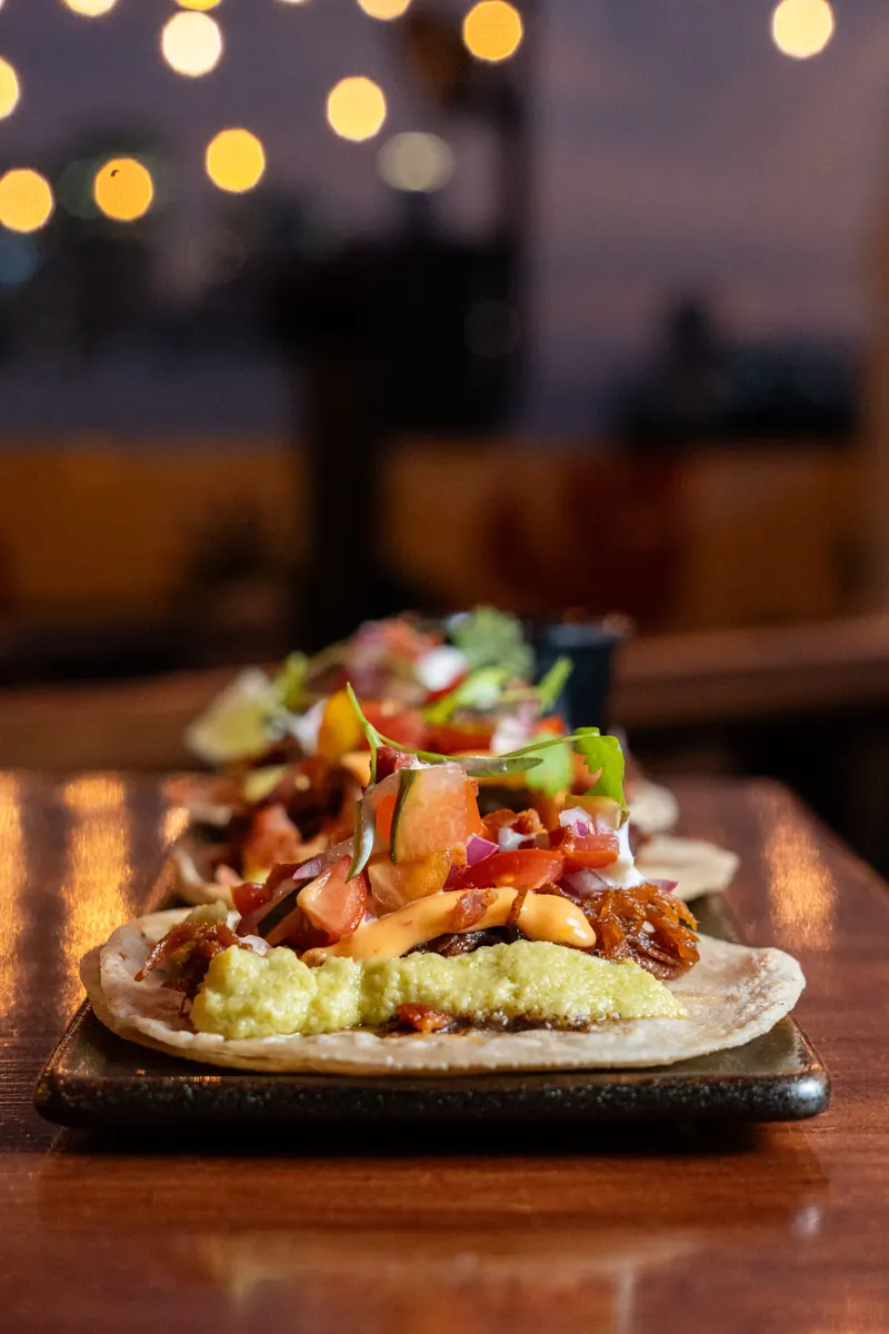 Tacos to share at the Terrat bar with string lights behind